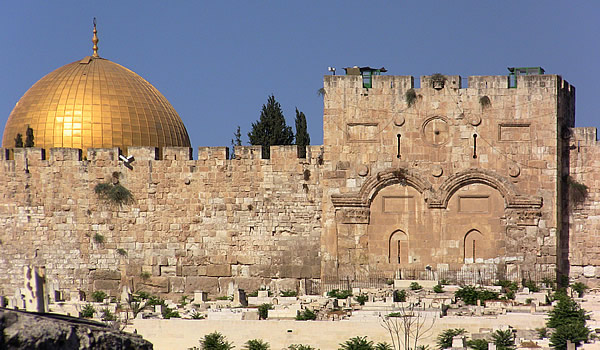 Eastern Gate with Muslim graves before the gate with top of the Dome of the Rock in the background.
